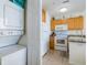 Kitchen with stacked washer/dryer, and featuring granite countertops and white appliances at 8800 Bay Pines Blvd # 318, St Petersburg, FL 33709