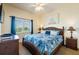 Comfortable bedroom with a bright window and tropical-themed furnishings at 8800 Bay Pines Blvd # 318, St Petersburg, FL 33709