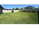 Backyard featuring green grass, vinyl fence, and privacy landscaping at 9736 Sage Creek Dr, Ruskin, FL 33573