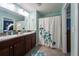 Bathroom featuring double sinks, granite countertops, and a shower/bath combo at 9736 Sage Creek Dr, Ruskin, FL 33573