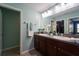 Bathroom boasts a double sink vanity with granite countertops, and stylish decor at 9736 Sage Creek Dr, Ruskin, FL 33573