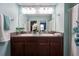 Bathroom featuring double sinks, granite countertops, and a decorative floral shower curtain at 9736 Sage Creek Dr, Ruskin, FL 33573
