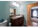 Bathroom featuring a vanity with a granite countertop, mirror and view to the bedroom at 9736 Sage Creek Dr, Ruskin, FL 33573