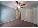 Bedroom with carpet, ceiling fan, and closet provides a comfortable and functional living space at 9736 Sage Creek Dr, Ruskin, FL 33573
