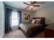 A bedroom featuring a ceiling fan, window, closet, and bed with decorative pillows and art at 9736 Sage Creek Dr, Ruskin, FL 33573