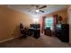 Bedroom with ceiling fan, carpet floors, and workstation with dual monitors at 9736 Sage Creek Dr, Ruskin, FL 33573