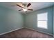 This bedroom features a ceiling fan and a window offering natural light at 9736 Sage Creek Dr, Ruskin, FL 33573