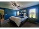 Bedroom with blue walls, ceiling fan, two windows and carpeted floors at 9736 Sage Creek Dr, Ruskin, FL 33573