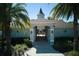 A beautifully landscaped entrance to the community clubhouse is framed by palm trees at 9736 Sage Creek Dr, Ruskin, FL 33573