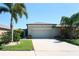 Front exterior of home with well-maintained landscaping, complemented by a lush lawn at 9736 Sage Creek Dr, Ruskin, FL 33573