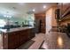 Open kitchen featuring granite countertops, stainless appliances, and seamless flow to living areas at 9736 Sage Creek Dr, Ruskin, FL 33573