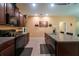 Well-lit kitchen with stainless steel appliances, granite counters, and seamless access to dining at 9736 Sage Creek Dr, Ruskin, FL 33573
