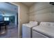 Laundry room with tile flooring, shelving, washer, and dryer at 9736 Sage Creek Dr, Ruskin, FL 33573