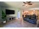 Open concept living room boasts tile floors, ceiling fan and views of the kitchen and dining area at 9736 Sage Creek Dr, Ruskin, FL 33573