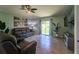 Cozy living room boasts sliding glass doors to backyard and neutral tile floors at 9736 Sage Creek Dr, Ruskin, FL 33573
