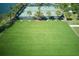 Aerial view of meticulously maintained tennis courts and lush green space lined with palms trees at 9736 Sage Creek Dr, Ruskin, FL 33573