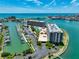 Waterfront condo complex with boat docks, tennis courts, swimming pool, and well-kept landscaping at 1 Key Capri # 301E, Treasure Island, FL 33706