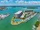 Waterfront condo complex with boat docks, a tennis court, pool and lush landscaping at 1 Key Capri # 301E, Treasure Island, FL 33706
