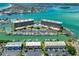 Waterfront condo complex featuring boat docks, tennis courts, a swimming pool and well-maintained grounds at 1 Key Capri # 301E, Treasure Island, FL 33706