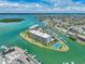 Stunning aerial view of waterfront condos with private docks, a tennis court, and beautiful coastal scenery at 1 Key Capri # 301E, Treasure Island, FL 33706