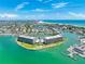 Expansive aerial view features waterfront condos with a pool, marina access, and stunning Gulf Coast vistas at 1 Key Capri # 301E, Treasure Island, FL 33706