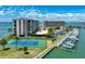 Waterfront condo complex featuring boat docks and a tennis court with stunning views of the water at 1 Key Capri # 301E, Treasure Island, FL 33706