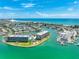 Breathtaking aerial shot showcases waterfront condos near a marina, offering stunning ocean views and coastal charm at 1 Key Capri # 301E, Treasure Island, FL 33706