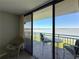 Enjoy waterfront views from this balcony, complete with seating area at 1 Key Capri # 301E, Treasure Island, FL 33706