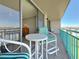 Inviting balcony with comfortable seating, perfect for relaxing and enjoying the water views at 1 Key Capri # 301E, Treasure Island, FL 33706