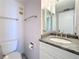 Neutral toned bathroom with modern fixtures, sleek mirrors, and ample vanity space at 1 Key Capri # 301E, Treasure Island, FL 33706