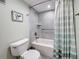 Well-lit bathroom features a combined tub and shower, alongside updated fixtures and modern tile at 1 Key Capri # 301E, Treasure Island, FL 33706