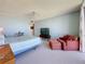 Spacious bedroom featuring a ceiling fan, carpet floors, and a relaxing sitting area at 1 Key Capri # 301E, Treasure Island, FL 33706
