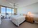 Bedroom with a sliding glass door to a balcony with a water view plus ceiling fan, and dresser at 1 Key Capri # 301E, Treasure Island, FL 33706