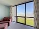 Large windows in this bedroom showcase expansive water views, enhancing the room's serene ambiance at 1 Key Capri # 301E, Treasure Island, FL 33706