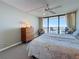 Bedroom with a sliding glass door to a balcony with a water view plus ceiling fan, and dresser at 1 Key Capri # 301E, Treasure Island, FL 33706
