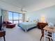 This cozy bedroom has a waterfront view and calming beach decor, ideal for a relaxing retreat at 1 Key Capri # 301E, Treasure Island, FL 33706