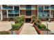 Building E entrance with palm trees and manicured landscaping leading to the doors in a condo community in Florida at 1 Key Capri # 301E, Treasure Island, FL 33706