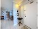 Condo entryway featuring tile flooring and providing a glimpse of the dining area, wall decor and front door at 1 Key Capri # 301E, Treasure Island, FL 33706