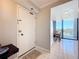 Condo entryway leading to a dining area and showcasing tile flooring, with a view of the water beyond at 1 Key Capri # 301E, Treasure Island, FL 33706