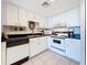 Well-lit kitchen featuring white cabinets, sleek countertops, and modern appliances at 1 Key Capri # 301E, Treasure Island, FL 33706