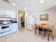 Charming kitchen area with tile flooring, appliances, and adjacent dining space at 1 Key Capri # 301E, Treasure Island, FL 33706