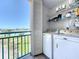 Enclosed laundry area with washer, dryer, and shelving at 1 Key Capri # 301E, Treasure Island, FL 33706