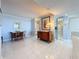 Open-concept living area featuring sleek tile floors and neutral décor at 1 Key Capri # 301E, Treasure Island, FL 33706
