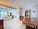 Inviting living room featuring tile floors, crown moulding and beautiful water views at 1 Key Capri # 301E, Treasure Island, FL 33706