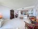 Open living area with tile floors, an adjacent dining area, and a built-in bar for seamless entertaining at 1 Key Capri # 301E, Treasure Island, FL 33706