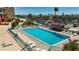 Large community pool surrounded by lounge chairs and tropical landscaping for residents to enjoy at 1 Key Capri # 301E, Treasure Island, FL 33706