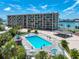 Beautiful aerial view of a condominium complex, pool, bar and waterfront with boat slips in the distance at 1 Key Capri # 301E, Treasure Island, FL 33706