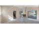 Open living room with high ceilings, fireplace, access to lanai/pool, and plenty of natural light at 1006 Chatham Ct, Safety Harbor, FL 34695