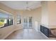 Bright sun room with tile flooring, fireplace, and french door access to pool at 1006 Chatham Ct, Safety Harbor, FL 34695