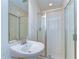 Bathroom featuring a pedestal sink, a frameless glass shower, and neutral wall tile at 10144 Arbor Run Dr # 122, Tampa, FL 33647